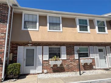 Charming townhouse featuring brick facade, white trim, and flower boxes under the windows at 2200 S Palmetto Ave # C040, Daytona Beach, FL 32119