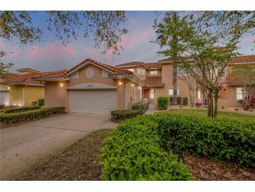 Charming home featuring a Spanish tile roof, landscaped yard, and an attached two-car garage at 3145 Connemara Dr, Ormond Beach, FL 32174