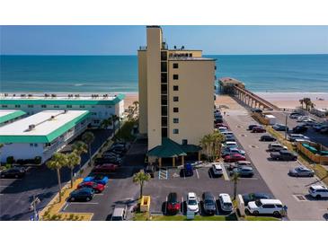 Condo building exterior with parking and a view of the ocean and pier at 3647 S Atlantic Ave # 5B, Daytona Beach, FL 32118