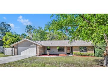 Charming single-story home with attached garage, brick accents, and well-maintained front lawn at 715 Oak Ter, Orange City, FL 32763
