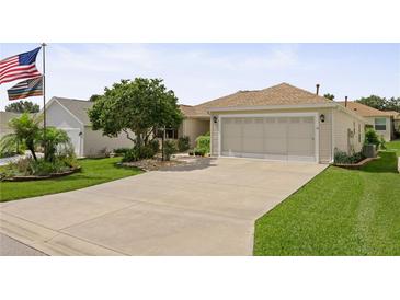 Charming single-story home featuring a well-manicured lawn and an attached two-car garage at 7462 Se 172Nd Fieldcrest St, The Villages, FL 32162