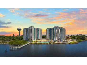 Stunning aerial view of two high-rise condos, featuring a pool, a pier, and gorgeous sunset at 935 N Halifax Ave # 309, Daytona Beach, FL 32118