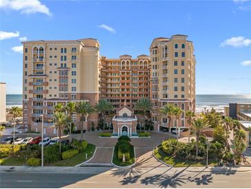 Luxurious beachfront condo building with lush landscaping and a grand entrance, offering upscale coastal living at 2515 S Atlantic Ave # 509, Daytona Beach, FL 32118