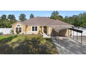 Charming single-story home featuring a two-car garage, carport, landscaped front yard, and inviting curb appeal at 2530 Leonard Dr, Deltona, FL 32725