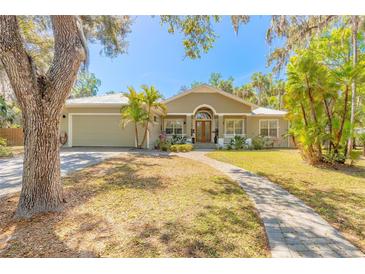 Inviting single-story home with a well-kept lawn, mature trees, and a welcoming entryway at 2646 Turnbull Bay Rd, New Smyrna Beach, FL 32168