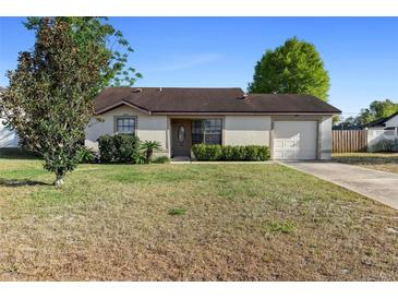 Charming single Gathering home featuring a well-maintained lawn and attached one car garage at 3237 Cranston St, Deltona, FL 32738
