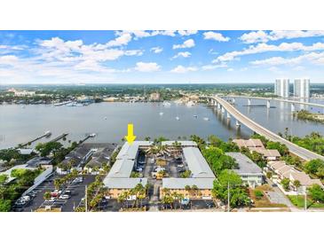 An aerial view of the property featuring bridge access, a waterfront, and plentiful parking at 411 N Halifax Ave # 304, Daytona Beach, FL 32118