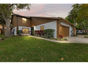 Charming two-story home with beautiful landscaping, lush lawn, and a two-car garage at 7 Appaloosa Trl, Ormond Beach, FL 32174