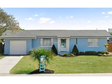 Charming one-story home with light blue paint, a well-manicured lawn, and tasteful landscaping at 111 Claire Ter, Daytona Beach, FL 32118