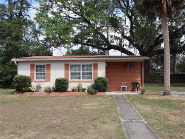 Charming single story home with red tile roof and simple, nicely maintained landscaping at 1151 Deltona Blvd, Deltona, FL 32725