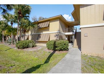 Inviting two-story condo with well-maintained landscaping and sidewalk entry at 120 Hibiscus Woods Ct # 2A, Deltona, FL 32725
