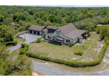 Expansive aerial view of the home, highlighting the lush landscaping and private surroundings at 125 Smyrna Dr, Debary, FL 32713