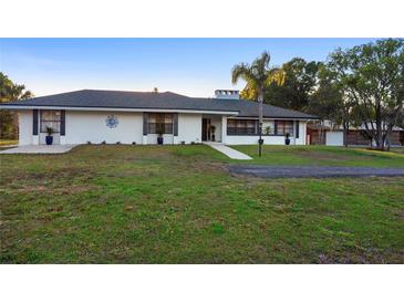 Ranch style home with a well manicured front yard at 1560 S Pearl St, Deland, FL 32720