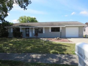 Charming single-story house featuring a garage and a well-maintained front lawn at 2936 Lantern Dr, South Daytona, FL 32119