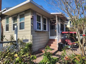 Charming home exterior with front porch, swing and brick steps at 503 5Th Ave, Daytona Beach, FL 32118