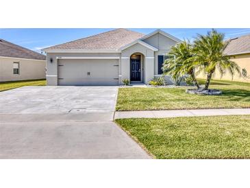 Charming single-story home with a well-maintained lawn and beautiful landscaping, offering great curb appeal at 5298 Bear Corn Run, Port Orange, FL 32128