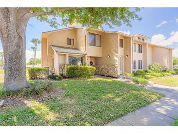 Charming two-story townhouse with stone accents and well-maintained landscaping on a sunny day at 124 Golden Eye Dr # A, Daytona Beach, FL 32119