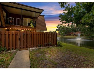 Charming condo overlooking a serene lake with a water fountain and lush landscaping, complete with a cozy upstairs balcony at 135 Moonstone Ct, Port Orange, FL 32129