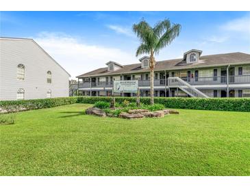 Well-maintained Riverside Condominiums features a lush green lawn, landscaping, and two-story buildings at 313 Dirksen Dr # G4, Debary, FL 32713