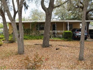Charming single-story home with mature trees and landscaping, offering a serene and inviting curb appeal at 34416 Oak Ave, Leesburg, FL 34788
