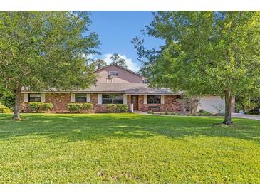 Charming brick home featuring a well-manicured lawn at 349 Evansdale Rd, Lake Mary, FL 32746