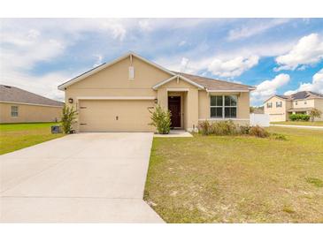 Charming single-story home featuring a two-car garage and well-maintained lawn in a suburban setting at 4273 Ne 29Th Pl, Ocala, FL 34470