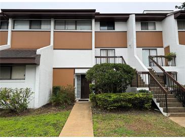 Inviting two-story townhomes featuring a well-maintained landscape, private entrances, and a clean, modern facade at 4555 Tower Pine Rd # Ge, Orlando, FL 32839