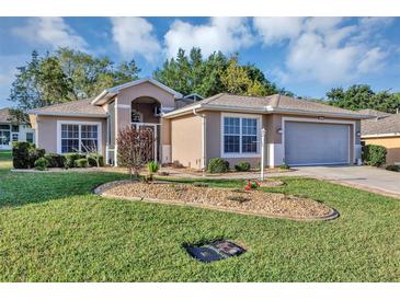 Charming single-story home with a well-manicured lawn and rock garden at 5305 Indian Ocean Loop, Tavares, FL 32778