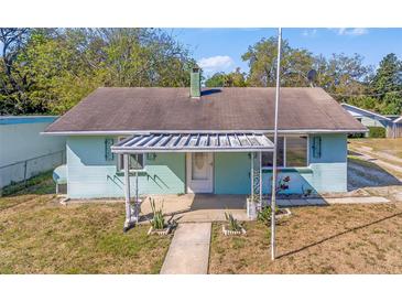 Charming home featuring a covered porch with unique architectural metal work and light blue siding at 630 Florida Ave, Daytona Beach, FL 32117