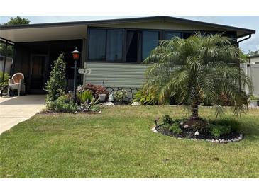 Well maintained home with manicured lawn and landscaping at 130 Oak Tree Dr, Debary, FL 32713