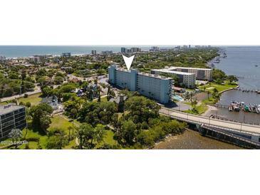 Stunning aerial view of the building with beach access, boat docks, and waterfront views at 100 Silver Beach Ave # 716, Daytona Beach, FL 32118