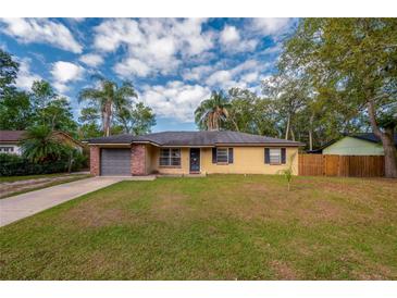 Charming single-story home with brick accents, a well-maintained lawn, and a driveway leading to a single-car garage at 105 Laguna Ct, Sanford, FL 32773