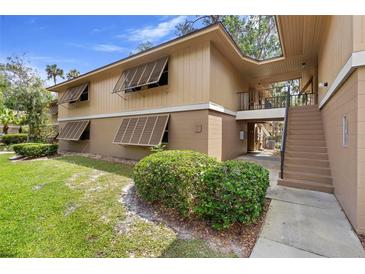 Charming two-story condo featuring shuttered windows and a well-maintained lawn at 110 Cypress Woods Ct # 2B, Deltona, FL 32725