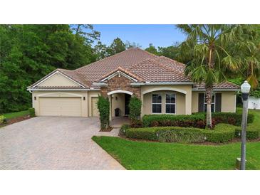 Charming single-Gathering home with brick driveway, well-kept landscaping, and a welcoming stone facade entrance at 115 San Marino Ln, Deland, FL 32724