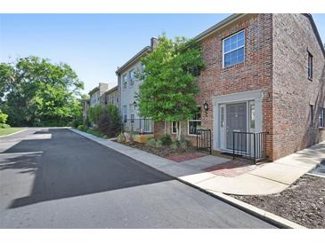 Attractive brick townhome featuring manicured landscaping and a private entryway at 117 N Garfield Ave # 16, Deland, FL 32724
