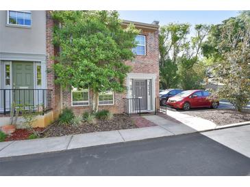 Charming brick townhome with well-maintained landscaping and dedicated parking spaces at 117 N Garfield Ave # 16, Deland, FL 32724