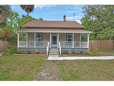 Charming two-story home with a welcoming front porch and well-maintained lawn at 310 Main St, Enterprise, FL 32725