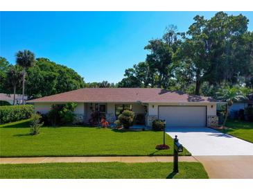 Charming single-story home with a well-maintained lawn, mature trees, and a two-car garage in a desirable location at 3441 Country Walk Dr, Port Orange, FL 32129