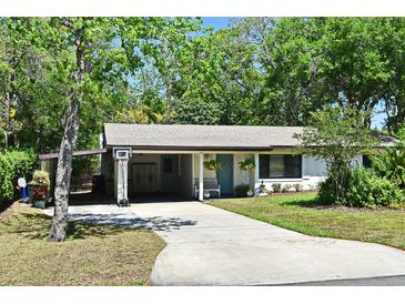 Charming single-story home featuring a covered carport, manicured lawn, and inviting curb appeal at 421 Hope Ter, Maitland, FL 32751