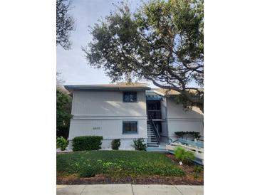 Inviting two-story exterior featuring well-maintained landscaping and stair access at 4401 Sea Mist Dr # 201, New Smyrna Beach, FL 32169