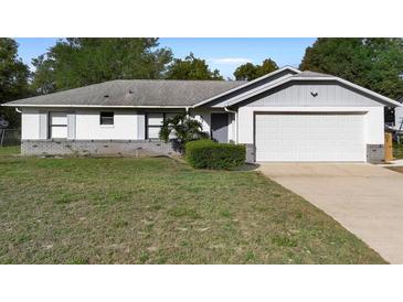 Charming single-story home with attached garage and well-maintained front lawn at 1627 Alloway Dr, Deltona, FL 32738