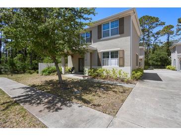 Charming two-story home featuring a covered front porch and manicured landscaping at 1655 Pham Dr, Port Orange, FL 32129