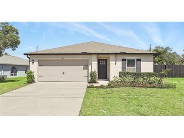 Charming single-story home with well-manicured lawn and attached garage at 223 Courtland Blvd, Deltona, FL 32738