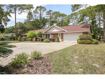 Charming single-story brick home with well-manicured landscaping and an inviting circular driveway at 2271 Springs Landing Blvd, Longwood, FL 32779