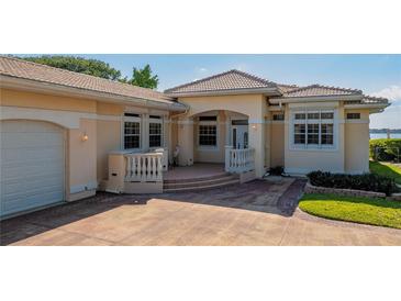 Elegant home featuring a tile roof, arched entryway, and well-manicured landscaping at 2542 S Peninsula Dr, Daytona Beach, FL 32118