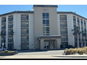 Multi-level condo building showing main entrance and black iron balconies at 2626 S Atlantic Ave # 1080, Daytona Beach, FL 32118