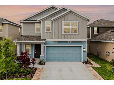 Charming two-story home showcasing a neatly manicured lawn, inviting exterior colors, and a two car garage at 2743 Gentle Rain Dr, Davenport, FL 33837
