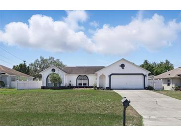 Charming single-story home with a well-maintained lawn and a two-car garage at 417 Jeffers St, Deltona, FL 32725