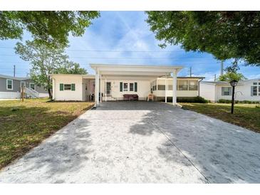 Charming single-story home with a covered carport and a well-maintained front yard at 44 Florence Blvd, Debary, FL 32713