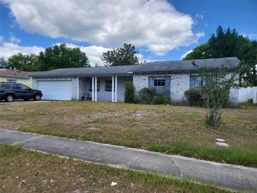 Charming single story house with a front yard and attached garage at 461 Marigold Rd, Casselberry, FL 32707